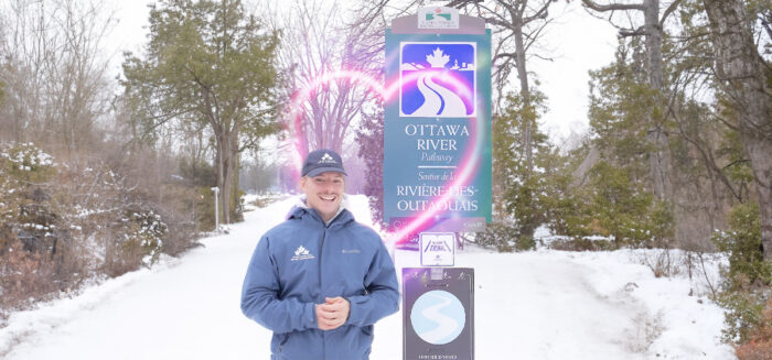 Tim Leger in front of a Trans Canada Trail sign