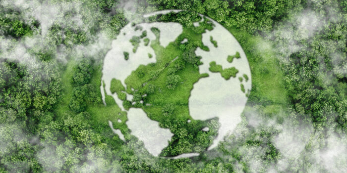 An Earth Month graphic of clouds over green grass and trees forming the shape of earth