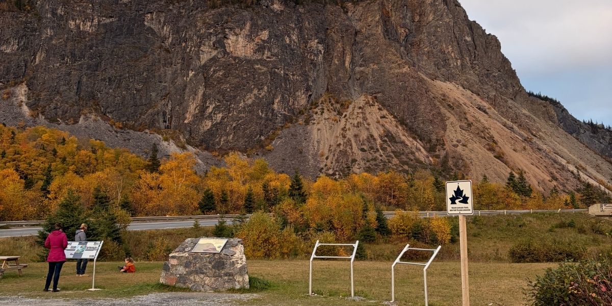 phpto of a mountain with plaque in the foreground during a fall day