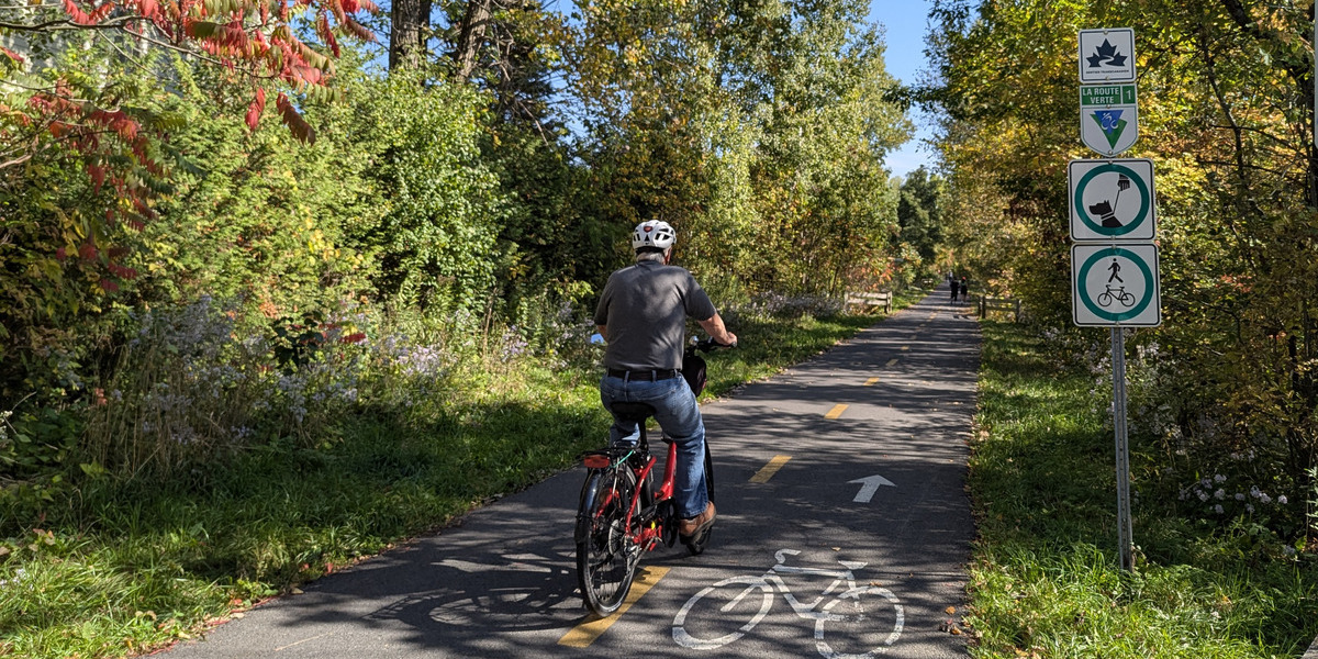 person riding a bike on a paved trail