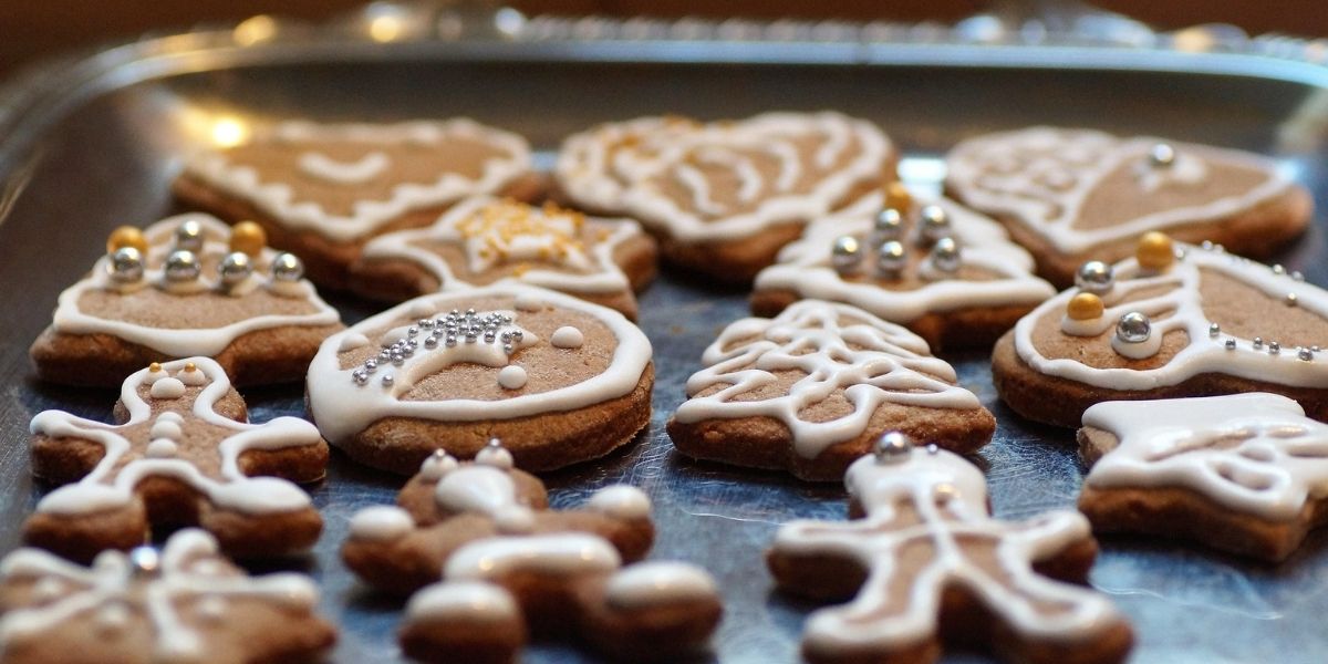 gingerbread cookies with frosting designs on a baking sheet