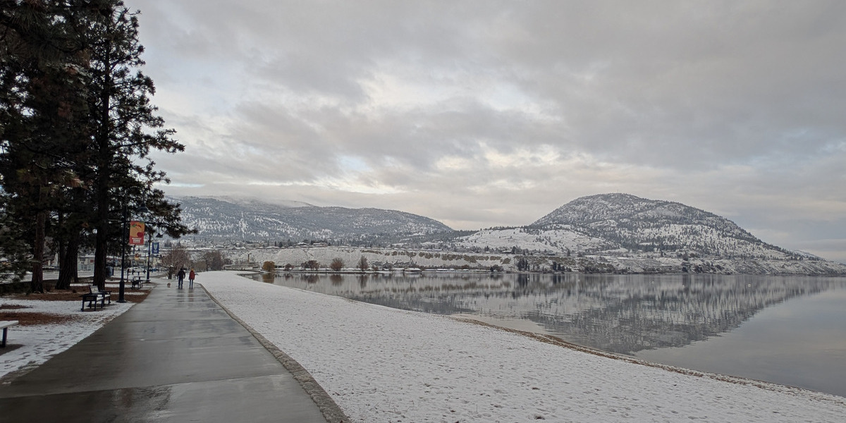 00Feature image_BC_story_winter-in-penticton_city-of-penticton_okanagan-lake-waterfront_Credit Off Track Travel | Trans Canada Trail path leading to snowy mountain range on a cloudy day
