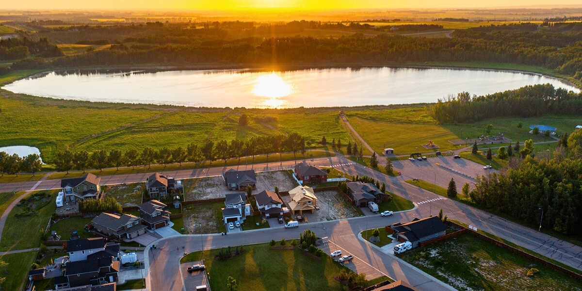 sunset overlooking a town and lake birdseye