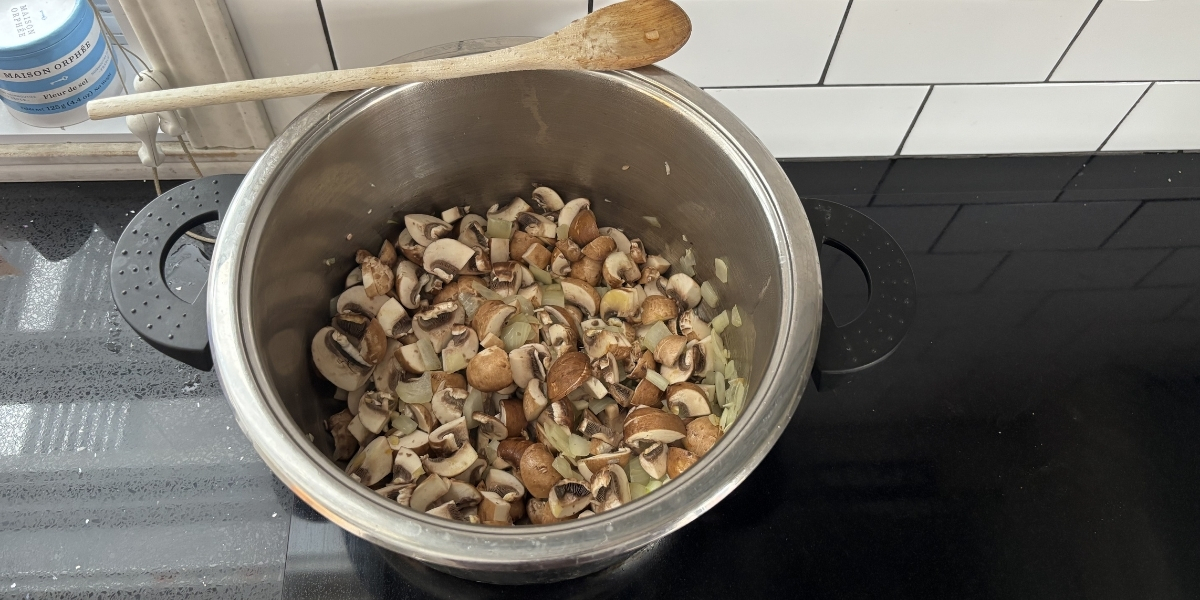 mushrooms and herbs in a bowl on oven