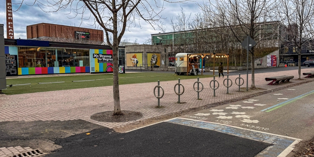 A bike path with a colourful building behind it