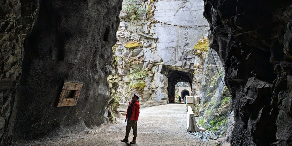 woman looking up at rock tunnels