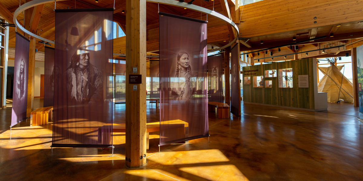 00Feature image_Indigenous History Month_photo credit Destination Canada - Jay R McDonald | Trans Canada Trail museum featuring indigenous faces and exposed wood