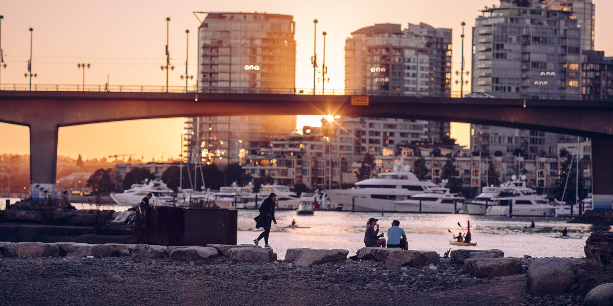 skyline view of a harbor with condo towers at sunset