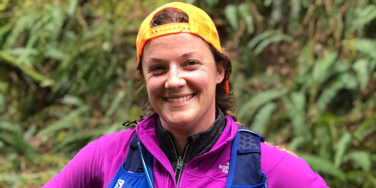 woman in running gear smiling