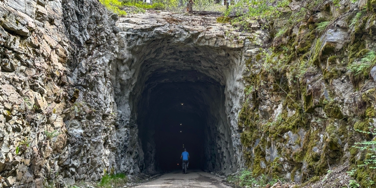 00Feature image_option 2_Adra Tunnels_credit Taryn Eyton | Trans Canada Trail large forest tunnel with cyclist inside