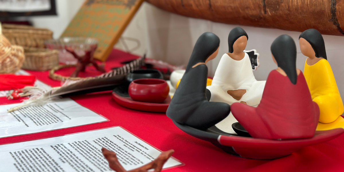 indigenous figurine of women gathered in a ceremonial circle